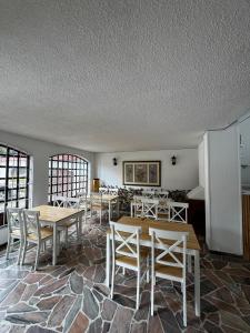 a dining room with tables and chairs in it at Casa Cocora in Bogotá