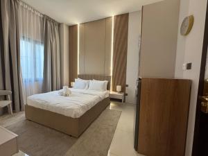 Postel nebo postele na pokoji v ubytování Signature Grand Studio Apartment