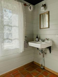a bathroom with a sink and a window at Historic 19Th Century Cottage In Blekinge in Kyrkhult +32 photos