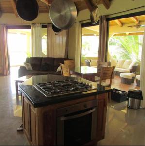 a kitchen with a stove top oven in a living room at Cabañas Time Out in Santa Catalina