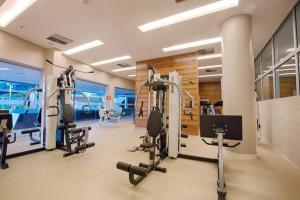 a gym with treadmills and ellipticals in a room at Alugueasy - Hotel Fusion in Brasilia
