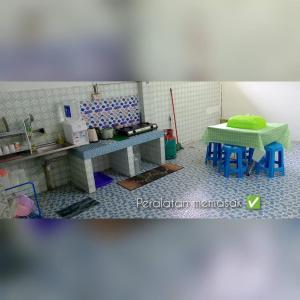 a kitchen with a sink and a table and chairs at Deelira Homestay Kuantan in Kuantan
