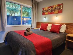 a bedroom with two beds with a stuffed animal on the bed at Plateau Lodge in National Park