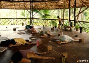 a group of people laying on the floor doing yoga at Dryft Darocotan Island in El Nido