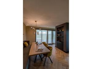a dining room with a table and chairs at Modern villa in De Cocksdorp near the beach in De Cocksdorp
