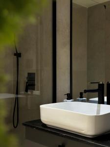 a bathroom with a white sink and a shower at Private Parking KING BED Urban Nest in Pittsburgh