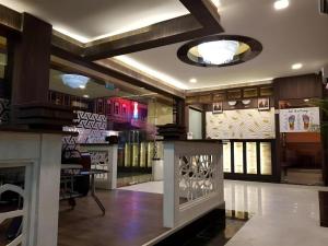 a lobby of a store with a table and chairs at Paragon Nagoya Hotel Batam in Nagoya