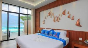 a bedroom with a large bed with a view of the ocean at The Green Hotel in Ko Lipe +220 photos