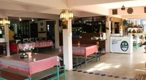 a restaurant with tables and chairs in a room at Monn Phu Phrai in Chiang Mai