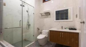 a bathroom with a shower and a toilet and a sink at Hoang Hung Hotel in Hanoi +99 photos
