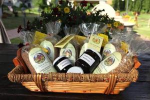 a basket of wine bottles and bread on a table at Azienda Agrituristica La Valle del Sambuco in Norcia