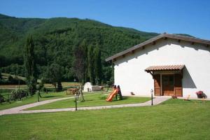 a building with two children playing in a playground at Azienda Agrituristica La Valle del Sambuco in Norcia