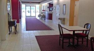 a living room with a table and chairs and a kitchen at Americas Best Value Inn Kinston in Kinston