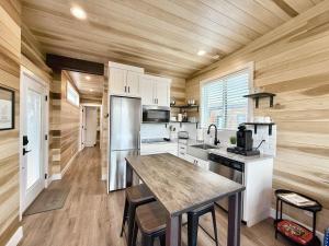 a kitchen with wooden walls and a wooden floor at Escalante Escapes Prickly Pear- Bunk Escape in Escalante