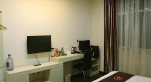 a hotel room with a desk with a computer on it at Thank Inn Hotel Hebei Xingtai Shaheweisan Road Expressway Intersection in Xingtai +24 photos