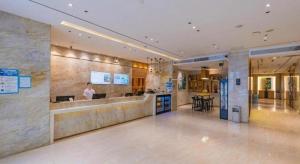 a lobby of a building with a bar in it at City Comfort Inn Shantou Huashan Road the MixC in Shantou