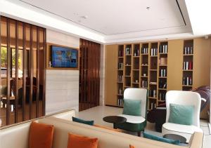 a living room with a couch and chairs at City Comfort Inn Hainan Tunchang Changsheng Road 