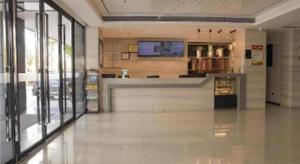 a large room with a bar in a building at City Comfort Inn Hainan Tunchang Changsheng Road 