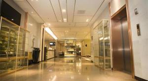 a large room with glass doors and a hallway at Echarm Hotel Changchun Jiutai District Government Railway Station in Changchun