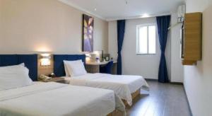 a hotel room with two beds and a window at 7 Days Premium Xianning Wenquan Shopping Center in Xianning