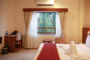 Una cama o camas en una habitación de PASSIONS HOTEL EDATHUA - Alappuzha 33 fotos más