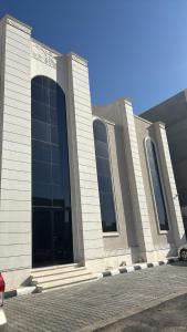 a large building with large windows on a street at شقه مميزه بغرفة نوم وصالة واسعه in Hafr Al Baten