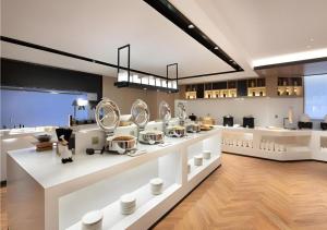 a store with white counters and mirrors on display at Echarm Hotel Shenyang Zhongjie North Station Metro Station in Shenyang