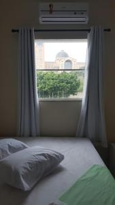Uma cama ou camas num quarto em Hotel Pousada do Papa