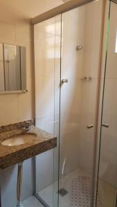a bathroom with a shower and a sink at Hotel Pousada do Papa in Aparecida