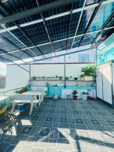 a balcony with tables and benches on a building at SEA HOME HOMESTAY in Ấp Bình Hưng +44 photos