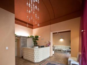 a lobby with a reception desk in a building at Hotel Palazzo Renieri - 3stelle S in Colle di Val d'Elsa