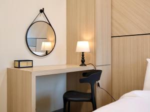 a bedroom with a desk with a mirror and a chair at DeOrient - deLofts Emporium 8Pax - VH17 in Kuching +36 photos