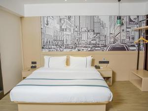 a bedroom with a large bed and a drawing of a city at City Comfort Inn Yangxin High-speed Railway Station in Huangshi +158 photos