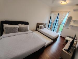 a bedroom with two beds and a large window at K Avenue Lucky Stay Suite in Penampang +29 photos