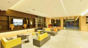 a lobby with couches and chairs in a building at Green Tree Inn Express Huainan Xiejiaji District Orient Guangji Hospital in Huainan