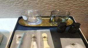a tray with two glasses on top of a table at Green Tree Inn Express Huainan Xiejiaji District Orient Guangji Hospital in Huainan