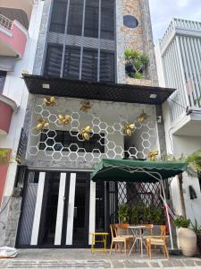 a building with bees on the side of it at MAIA Hotel & Apartment Danang in Da Nang