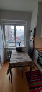 a living room with a table in front of a window at Wonderful Stay Helsingborg in Helsingborg