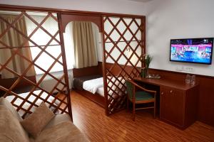 a room with a room with a bed and a desk at Hotel Saraj in Sarajevo