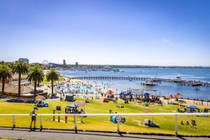 a group of people playing in the water at a beach at Pet Friendly, Flex Check-InOut, Australiana Touch in Geelong West