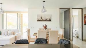 a living room with white furniture and a table at Apto Premium con vista al Mar en Pozos Colorados in Playa Bello Horizonte