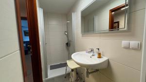 a bathroom with a sink and a shower at Lutkistube in Lübben  +10 photos