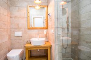 a bathroom with a sink and a shower and a toilet at Luksuzne sobe Luce in Vrbnik