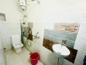 a bathroom with a toilet and a sink at Mirvana Guest House & Camel safari in Jaisalmer