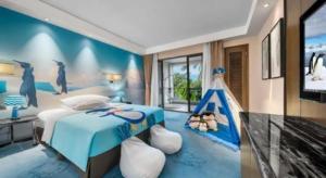 a bedroom with a blue bed with a play tent at Country Garden Phoenix Hotel Nanchong in Nanchong