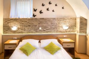 a bedroom with a bed with bats on the wall at Rooms & Apartments Kepic, AIRPORT accomodation in Cerklje na Gorenjskem