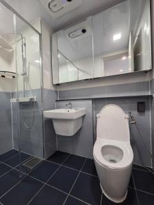 a bathroom with a toilet and a sink and a shower at Central H apartment Grande in Busan +33 photos