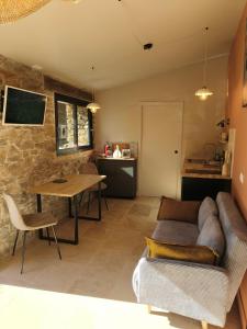 una sala de estar con un sofá y una mesa en La Grange d'Andrea, en Saint-Étienne-de-Fontbellon