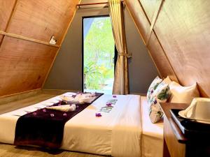 a bed in a room with a window at River Nest Hostel in Kampot +156 photos