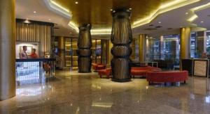 a lobby with columns and couches in a building at Gajahmada Avara Boutique Hotel in Pontianak